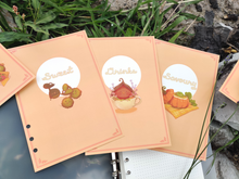 Load image into Gallery viewer, Dividers to organise your recipes. The sweet divider contains korpokkur shaped cookies for your sweet tooth. Quench your thirst with a lavender vanilla bean latte on the drinks divider. A korpokkur uses a soup within a pumpkin gourd as a spa on the savoury divider.