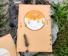 Load image into Gallery viewer, The back cover consists of two yukinkos snuggled in an autumn tree. They provide the most important ingredient to the soup: love. There are hanging herbs extending from the tree to the edges of the page. These should match up with the front page.