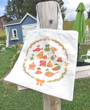 Load image into Gallery viewer, Korpokkur tote bag on a fence post ready for you to grab and go. Or blow off in the wind, whichever comes first. Colours are more vivid this time around!
